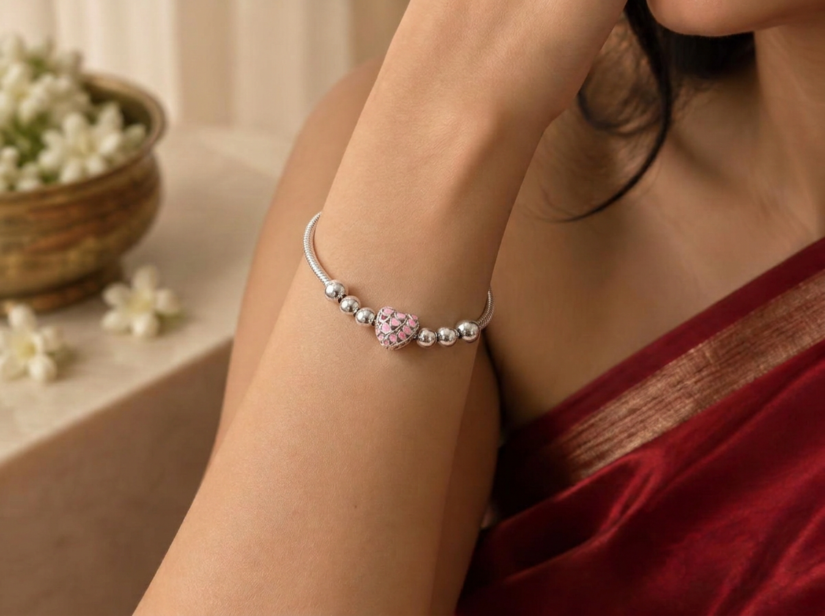 Ishq silver charm bracelet worn on the wrist